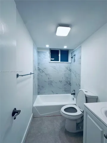 a bathroom with a toilet a sink and bathtub