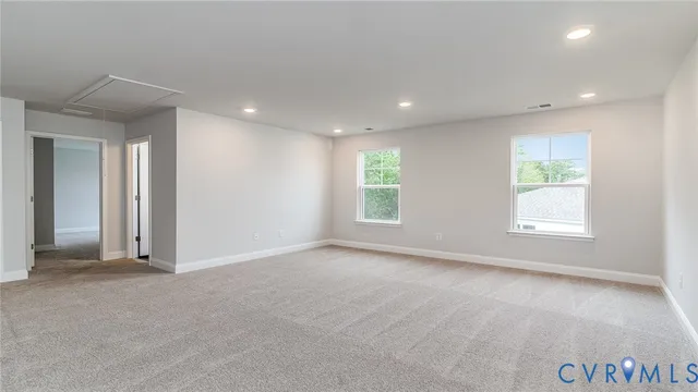 an empty room with windows and closet
