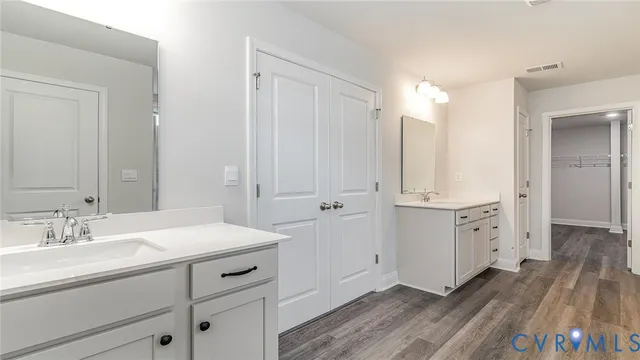 a bathroom with a sink a mirror and a vanity