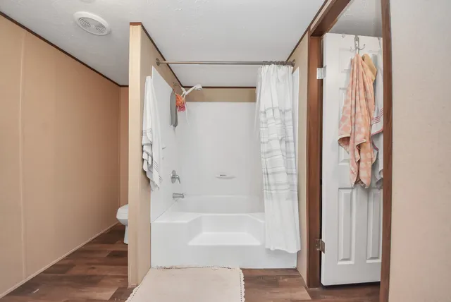 a bathroom with a bathtub and a shower