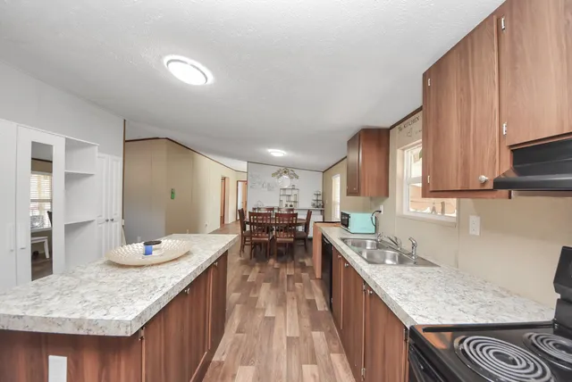 a kitchen with granite countertop lots of counter top space and stainless steel appliances