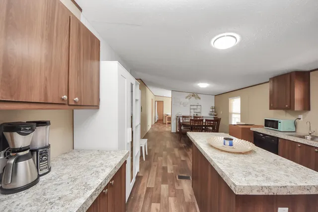 a kitchen with sink refrigerator and cabinets