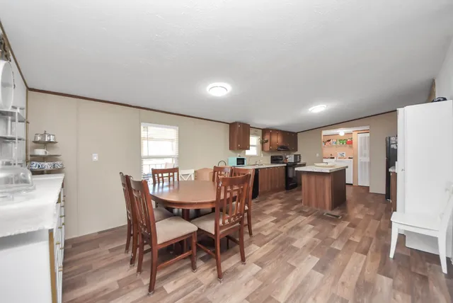 a view of a dining room with furniture and wooden floor