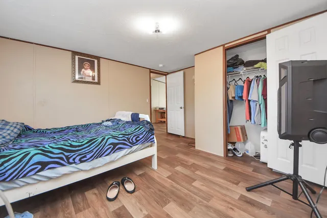 a bedroom with a bed and a walk in closet