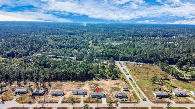 a view of a house with backyard and porch