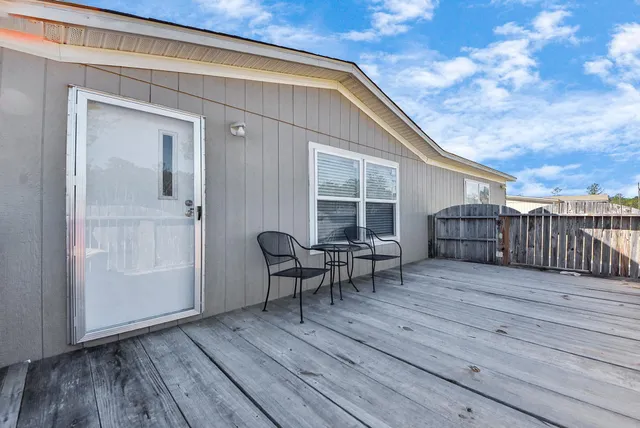 a view of deck with wooden floor and seating space