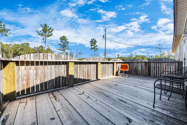 a view of a balcony with wooden floor