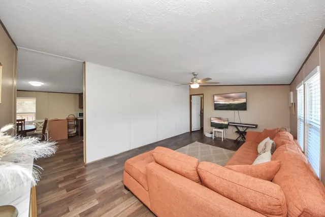 a living room with furniture and a wooden floor