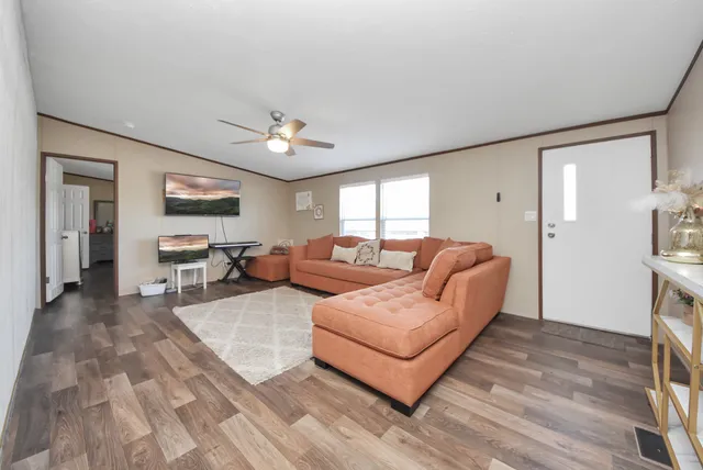 a living room with furniture and a chandelier