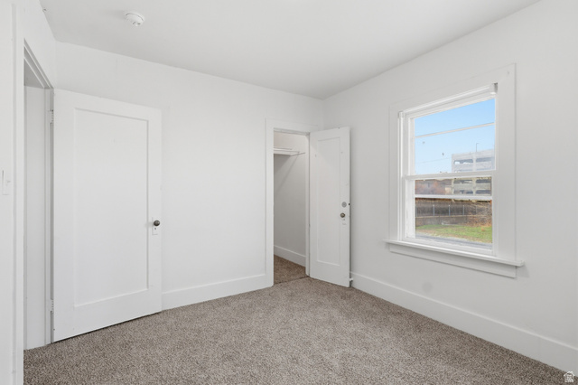 871 North 700 East Logan, UT 84321 - Photo 13 of 20 Unfurnished bedroom featuring baseboards and light carpet