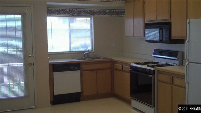 7534 Devonshire Lane Reno, NV 89511 - Photo 4 of 8 a kitchen with a stove and a microwave