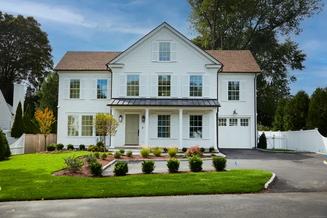 a front view of house with yard and green space