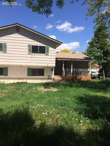 4415 Beaumont Road Colorado Springs, CO 80916 - Photo 6 of 29 View of back yard and deck that is covered.