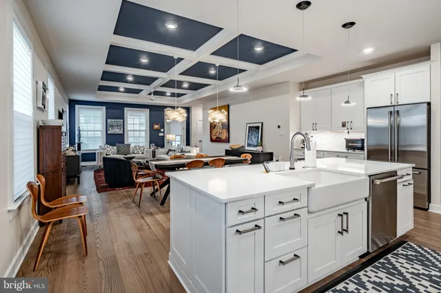 a kitchen with counter top space a sink stainless steel appliances and cabinets