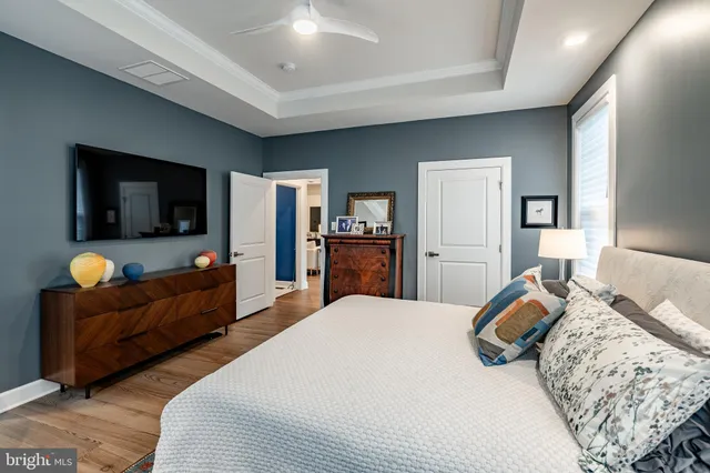 a bedroom with a bed and flat screen tv