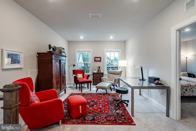 a living room with furniture a rug and a flat screen tv