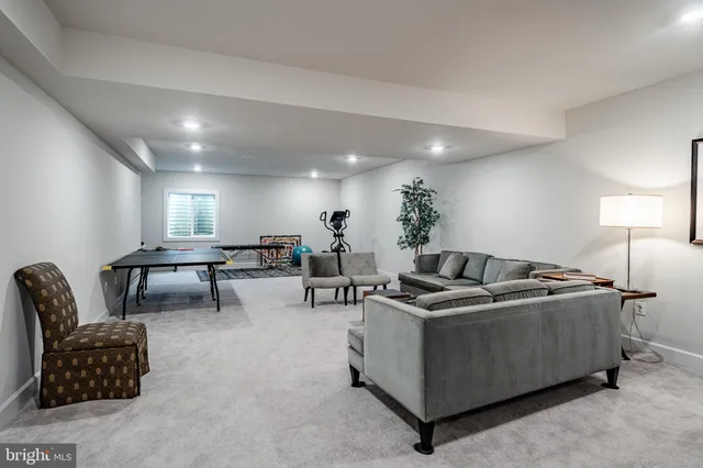 a living room with furniture and a lamp