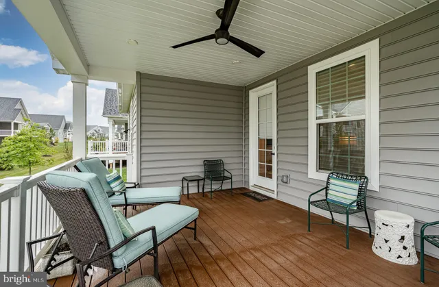 a balcony with furniture and wooden floor