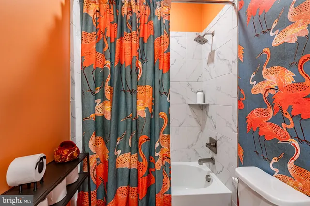 a bathroom with a bathtub and toilet