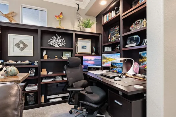 a living room with furniture and view of kitchen