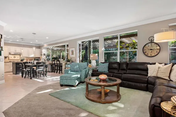 a kitchen with a table chairs refrigerator and cabinets