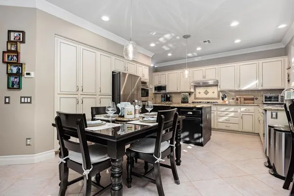 a kitchen with kitchen island granite countertop a sink stove and cabinets