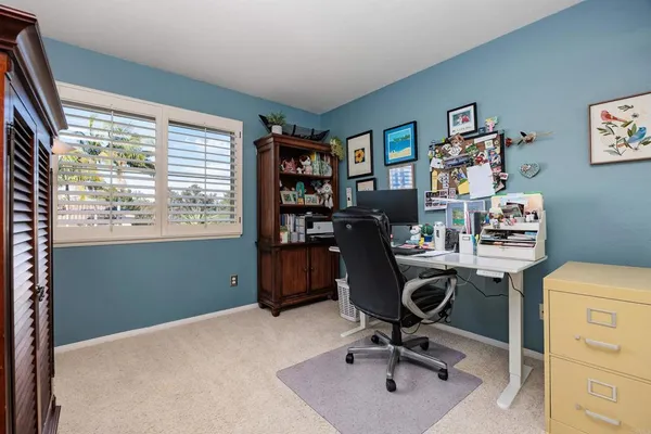 a patio with table and chairs and potted plants