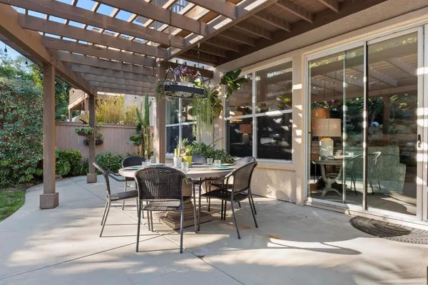 a outdoor dining space with furniture and garden view