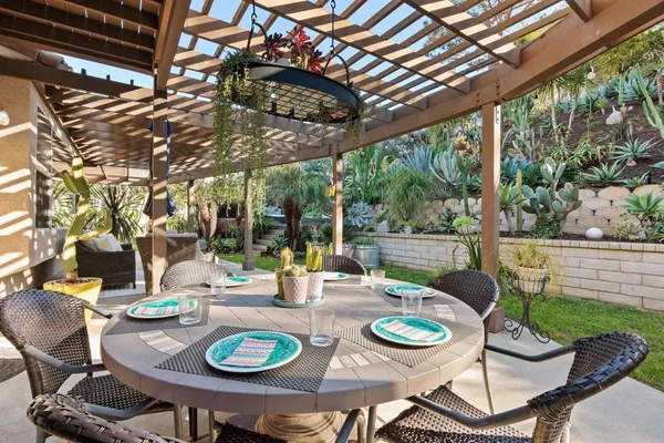 a view of a patio with couches chairs and a yard