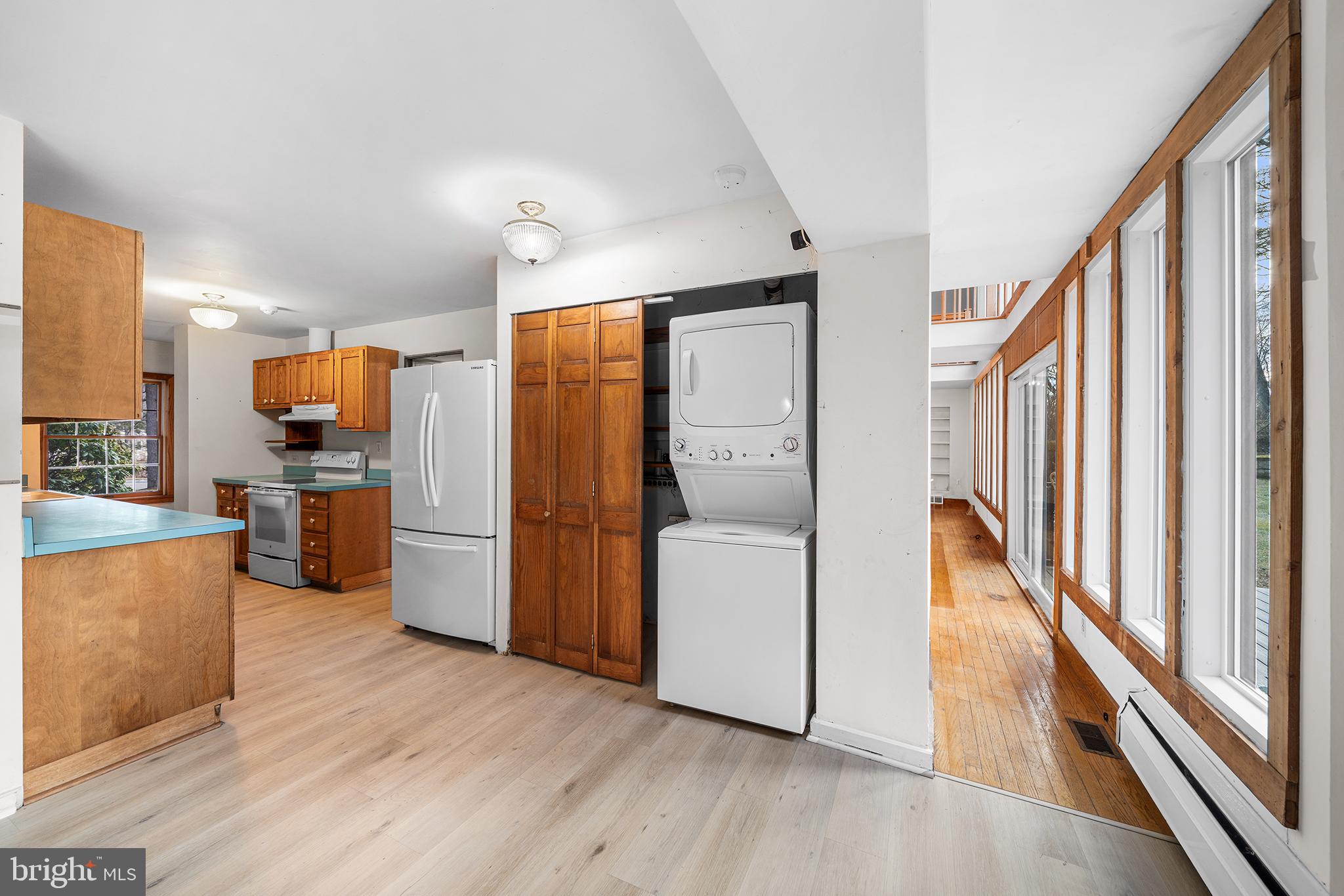 906 Hunt Road Newtown Square, PA 19073 - Photo 11 of 40 a view of a kitchen with a refrigerator a stove top oven and wooden floor