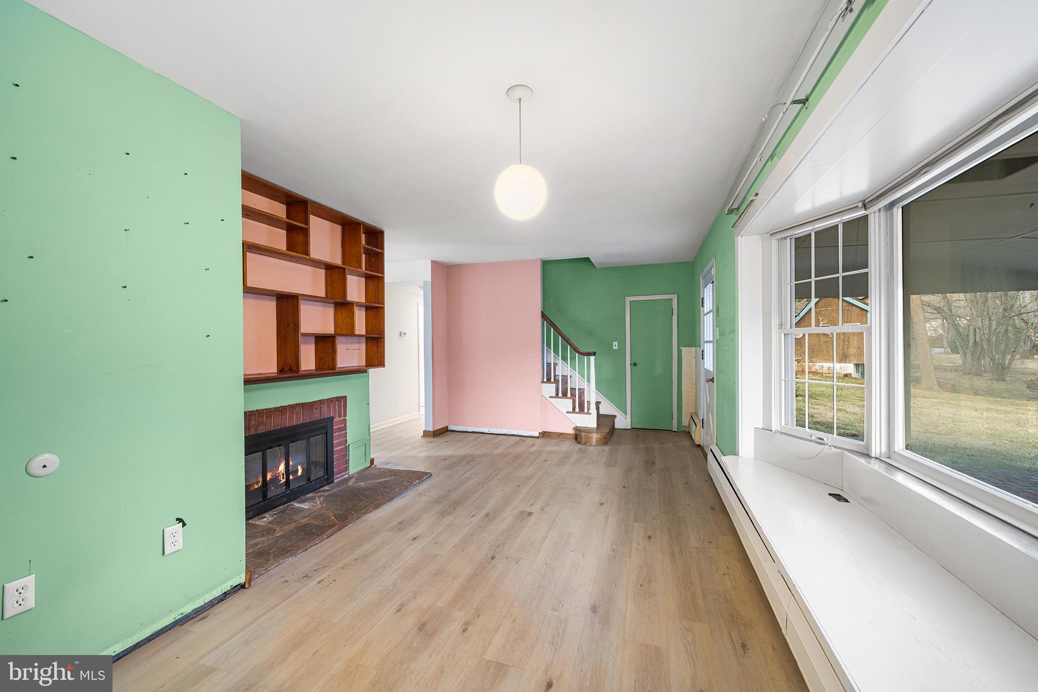 906 Hunt Road Newtown Square, PA 19073 - Photo 14 of 40 a view of an empty room with a fireplace and a window