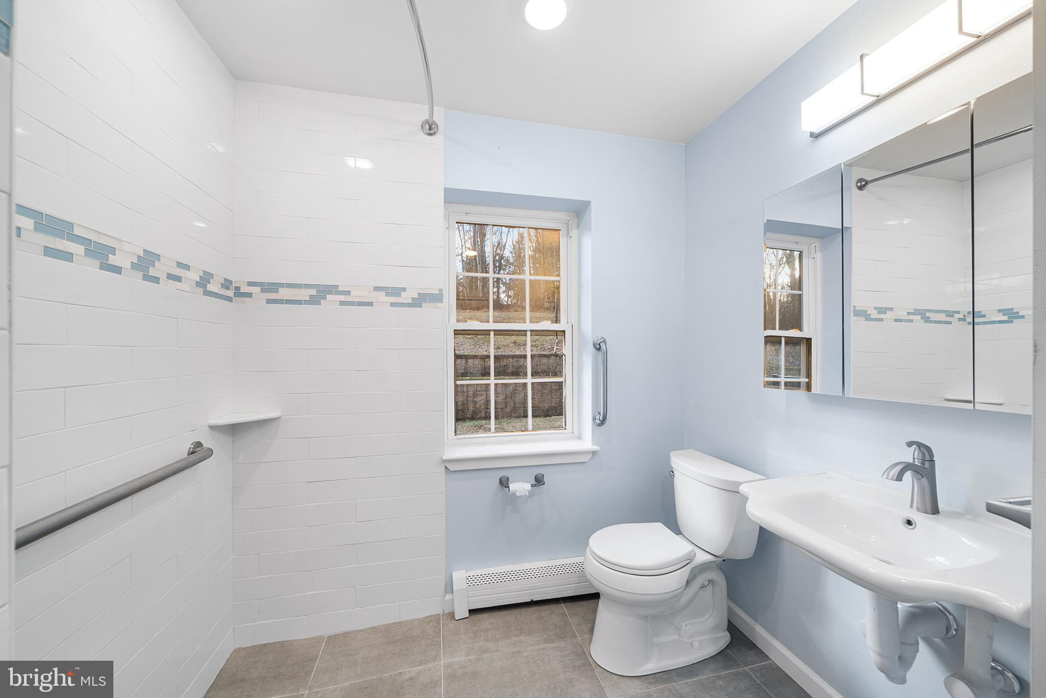 906 Hunt Road Newtown Square, PA 19073 - Photo 17 of 40 a bathroom with a toilet sink and mirror