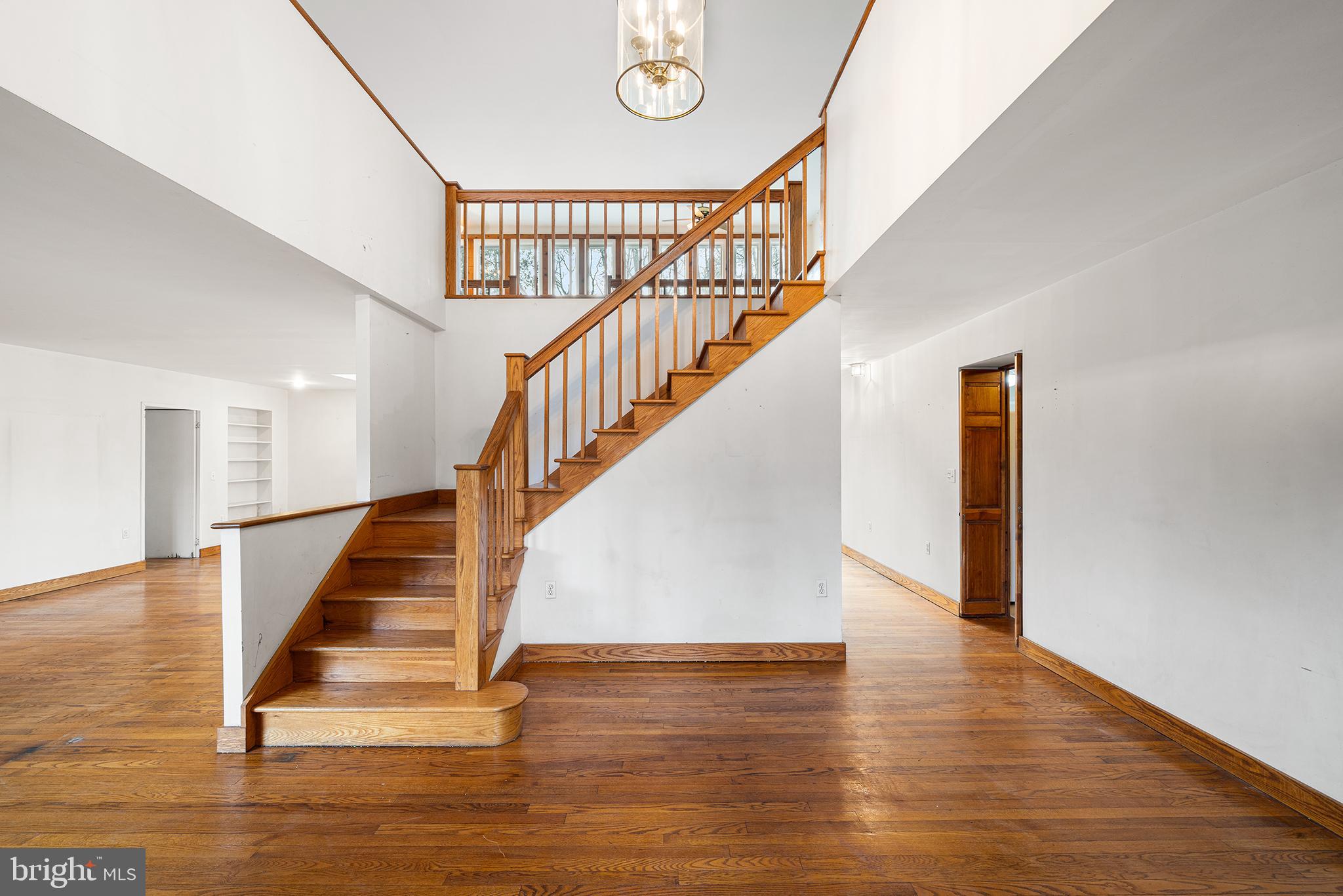 906 Hunt Road Newtown Square, PA 19073 - Photo 19 of 40 a view of staircase with white walls and a floor to ceiling window