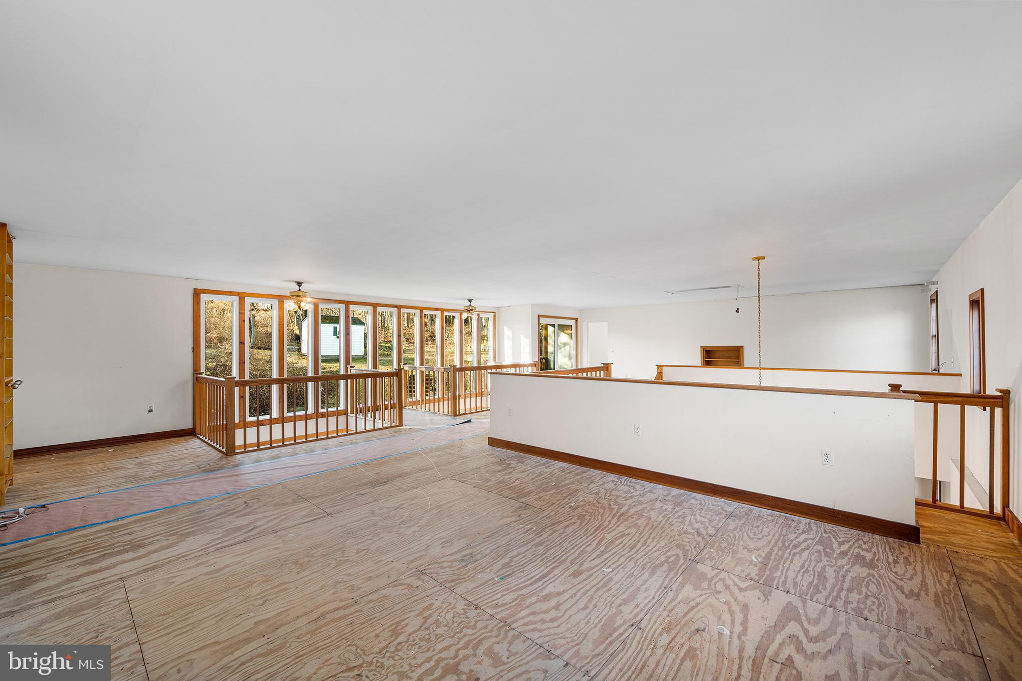 906 Hunt Road Newtown Square, PA 19073 - Photo 24 of 40 a view of a big room with wooden floor and windows