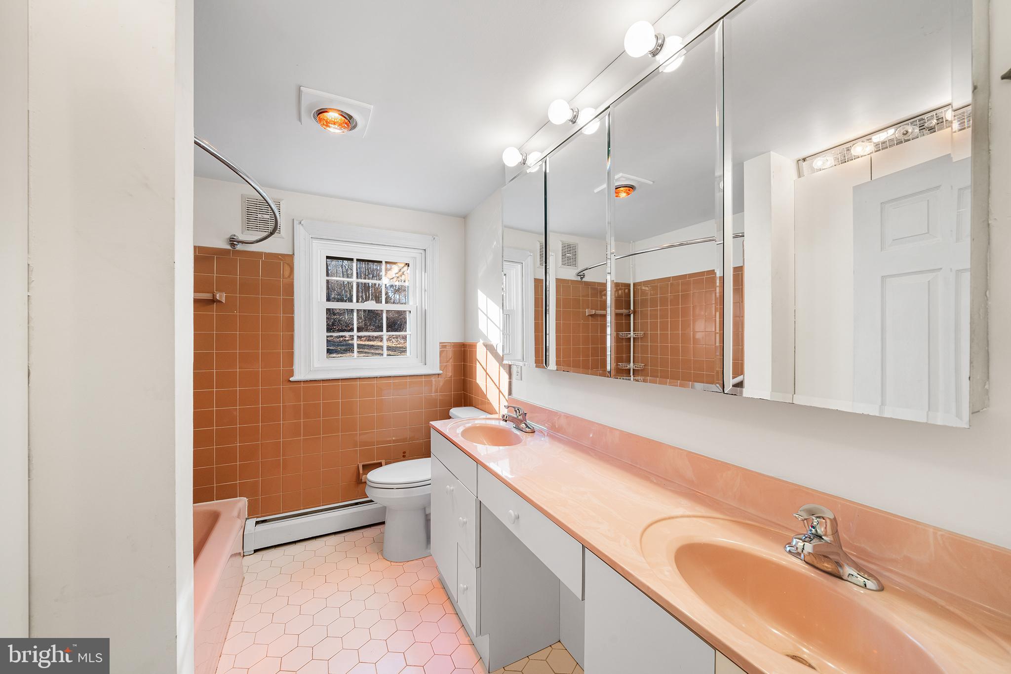 906 Hunt Road Newtown Square, PA 19073 - Photo 27 of 40 a bathroom with a sink a toilet and a mirror