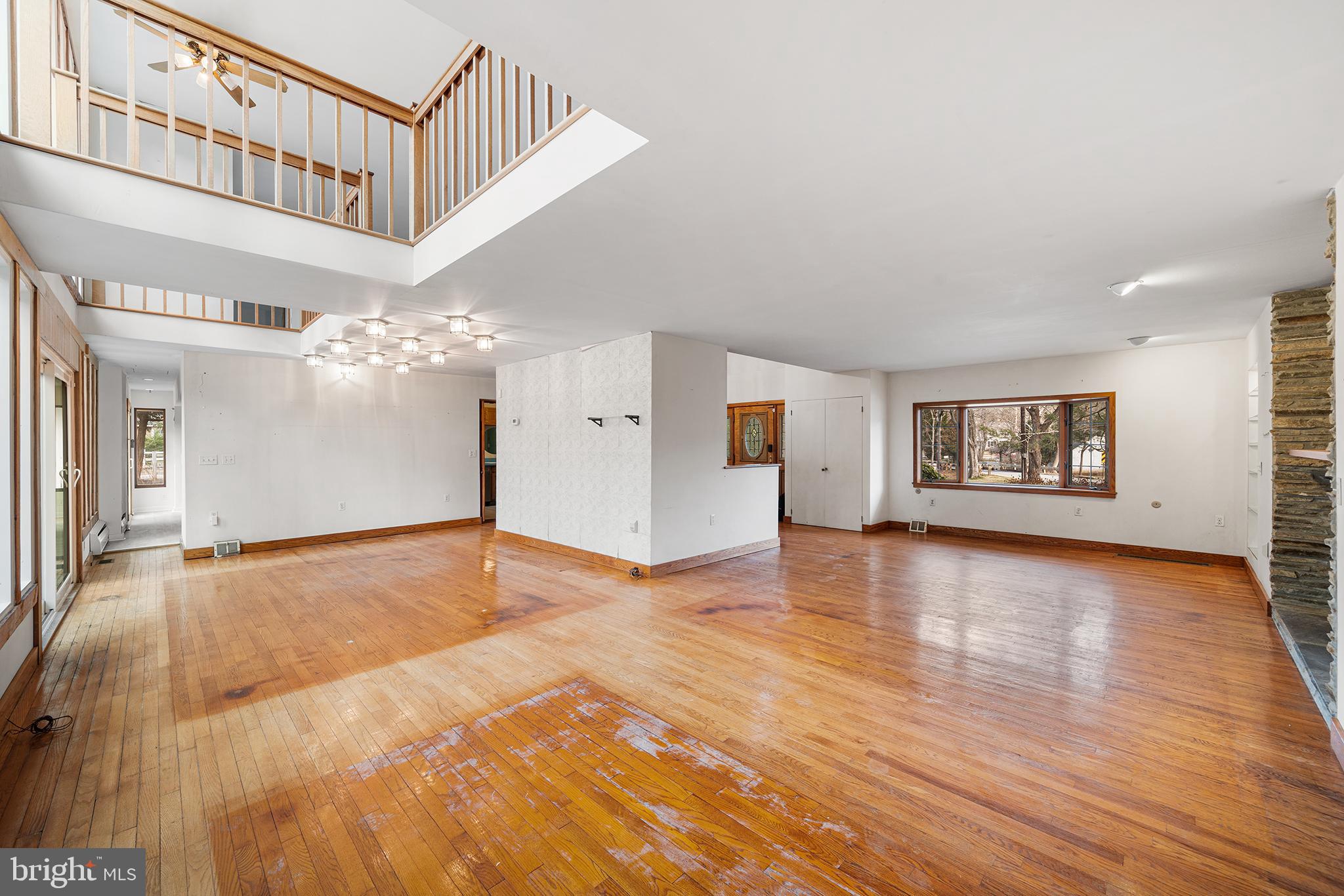 906 Hunt Road Newtown Square, PA 19073 - Photo 6 of 40 a view of an empty room with chandelier and wooden floor
