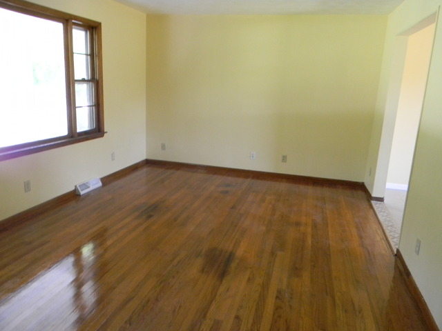 169 Swanson Road Sycamore, IL 60178 - Photo 11 of 11 an empty room with wooden floor and windows