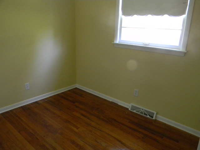 169 Swanson Road Sycamore, IL 60178 - Photo 3 of 11 a view of a small space with wooden floor and a window