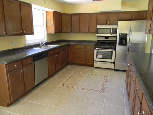 169 Swanson Road Sycamore, IL 60178 - Photo 5 of 11 a kitchen with a sink a stove and cabinets