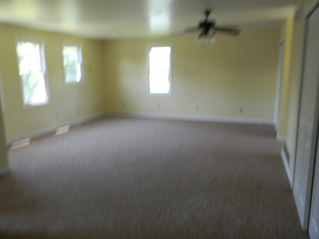 169 Swanson Road Sycamore, IL 60178 - Photo 8 of 11 an empty room with windows and mirror
