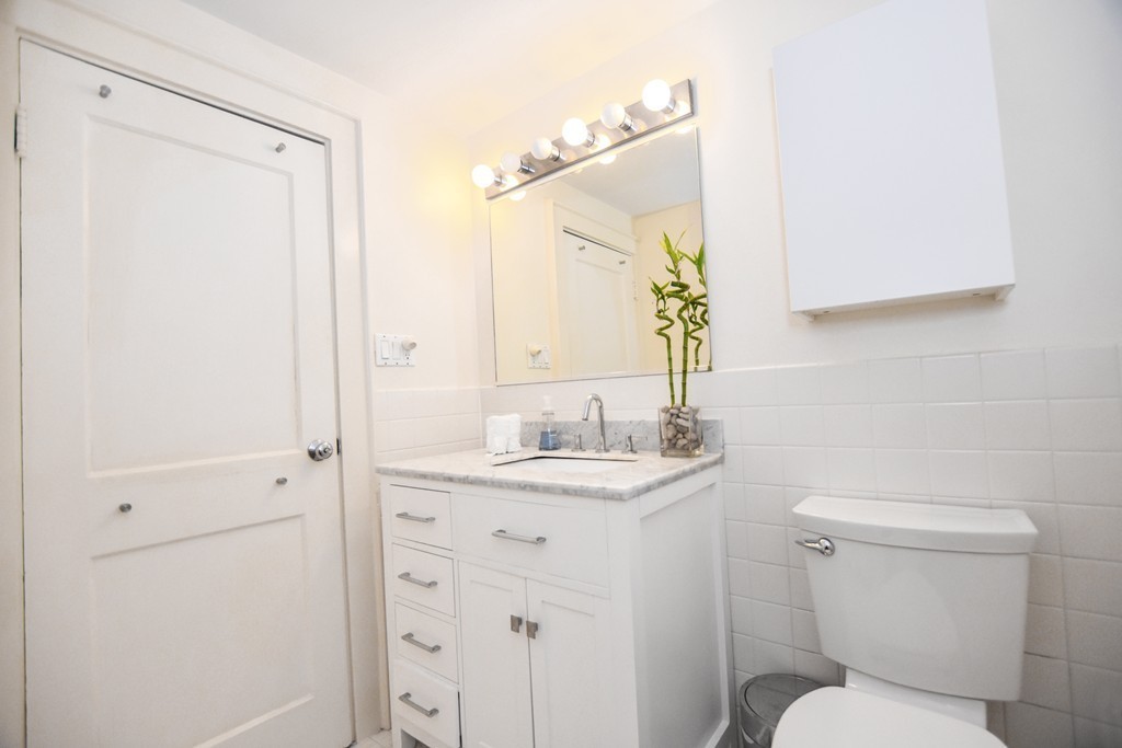 47 Ellison Road Newton, MA 02459 - Photo 13 of 18 a bathroom with a toilet a sink and mirror