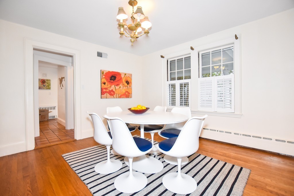 47 Ellison Road Newton, MA 02459 - Photo 5 of 18 a dining room with furniture a rug a chandelier and wooden floor
