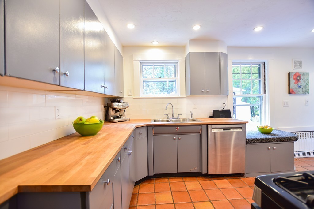 47 Ellison Road Newton, MA 02459 - Photo 6 of 18 a kitchen with a sink stove and cabinets