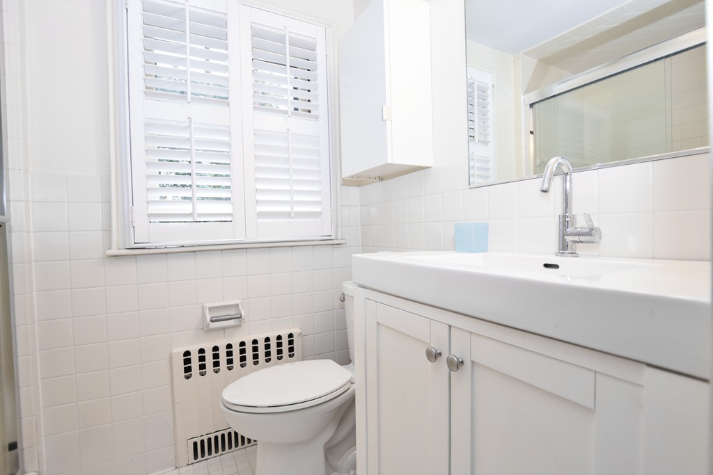 47 Ellison Road Newton, MA 02459 - Photo 10 of 18 a bathroom with a sink a toilet and a window