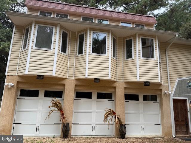 a view of a white house with large windows