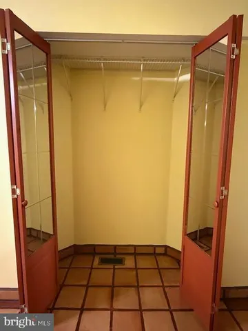 a bathroom with a sink a toilet a mirror and shower