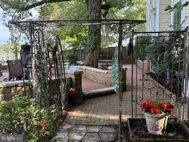 a view of a terrace with couches and wooden fence