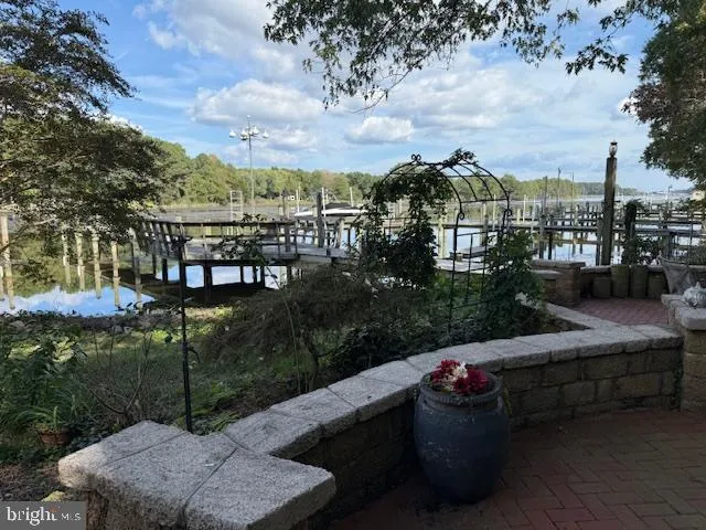 a view of a patio with couches chairs and a fire pit