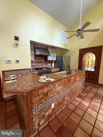 a kitchen with stainless steel appliances granite countertop a sink and cabinets