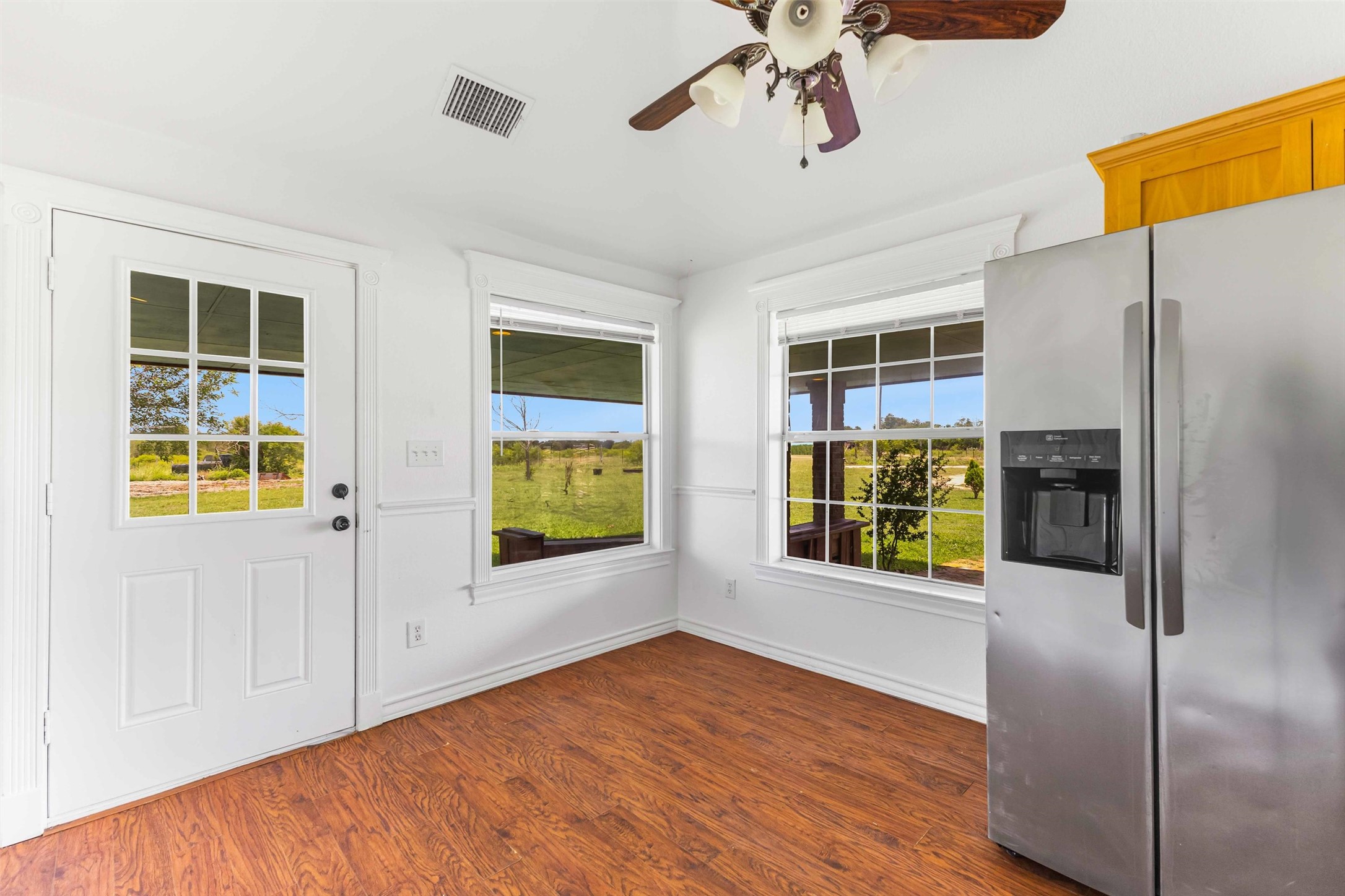 12212 Ballerstedt Road Elgin, TX 78621 - Photo 15 of 39 Entryway featuring ceiling fan and wood finished floors